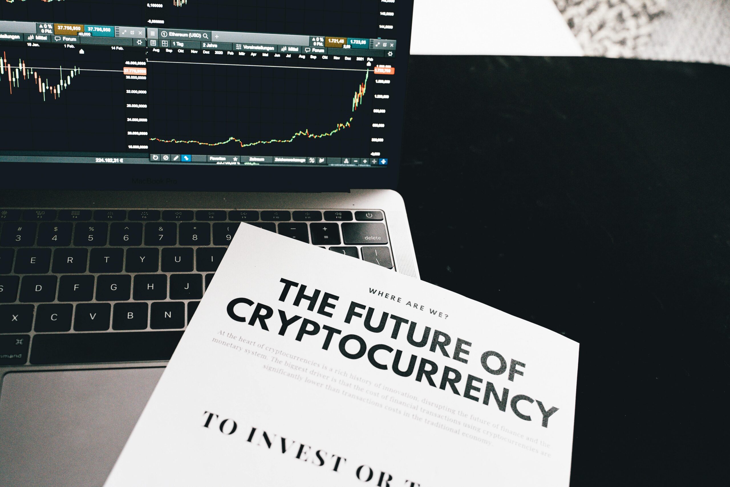 A detailed look at cryptocurrency market trends using a laptop and analytical document.